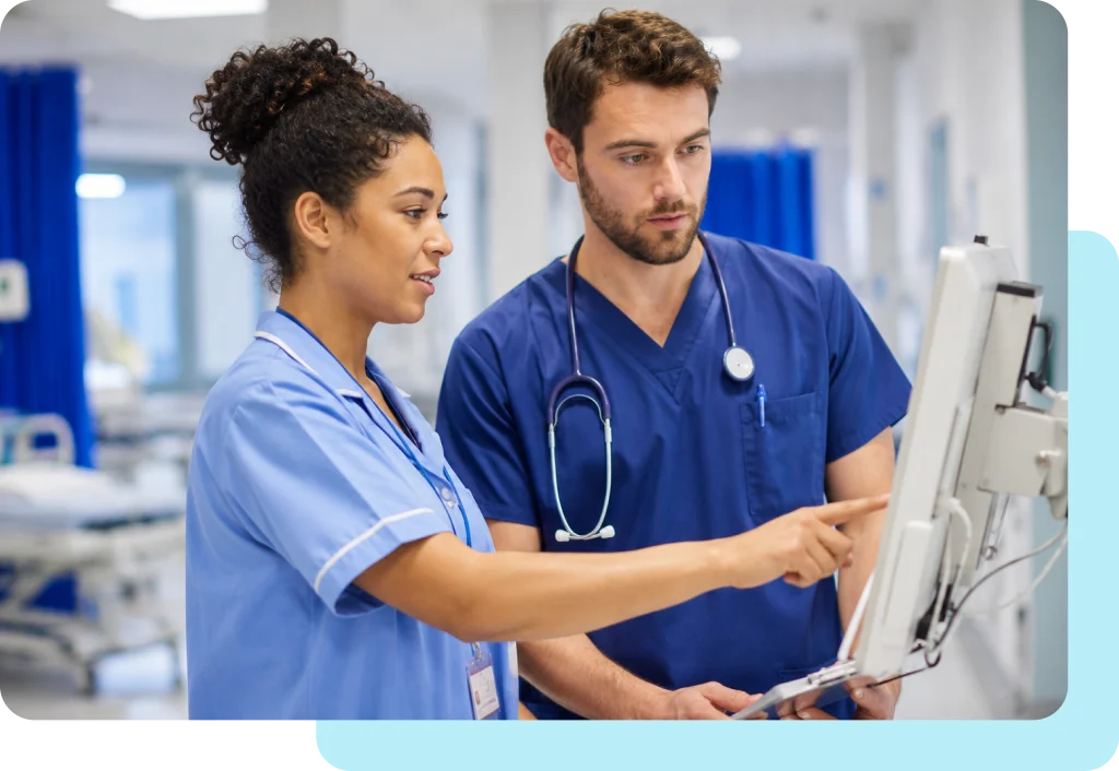 hospital nurse and doctor looking at equipment in ward